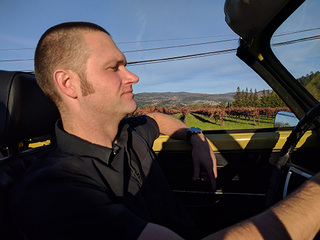 Kyle driving a Karmann Ghia convertible in wine country